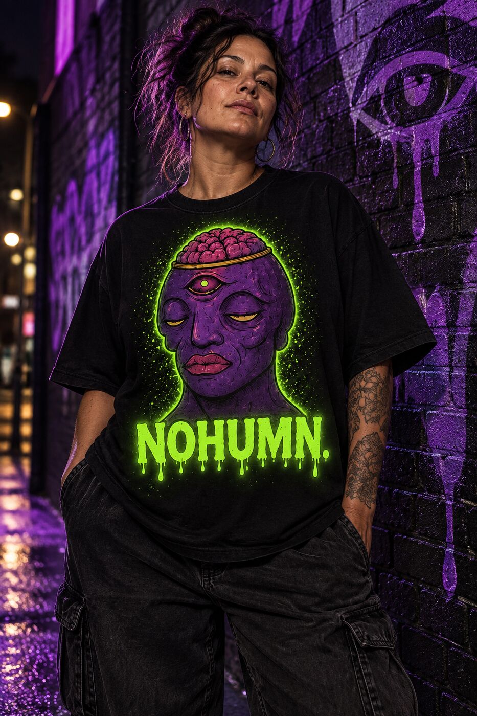 Adult streetwear model wearing the black NOHUMN glow shirt beside a purple graffiti wall
